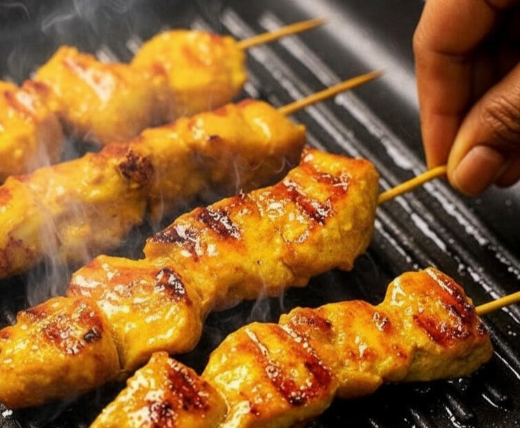 Chicken Satay Skewers Plate of six steamed pork dim sims with carrot and cabbage filling, served warm and tender.